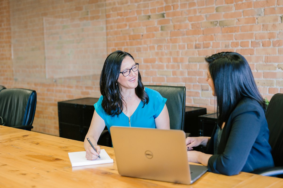 Senior financial advisor reviewing personalized growth strategy with clients in conference room